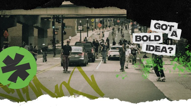 group of skateboarders flood a street through a downtown area with Send It stickers and the message Got A Bold Idea over top